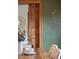 Dining room close-up showing green wall, art, table setting, and wood door at 2845 Quitman St, Denver, CO 80212