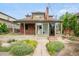 Charming home featuring a brick facade, sunroom, and landscaped front yard at 2845 Quitman St, Denver, CO 80212