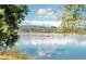 Gorgeous view of the lake with kayakers, mountains and reflections of clouds at 2845 Quitman St, Denver, CO 80212