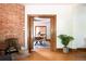 Inviting living room featuring a brick fireplace and doorway to the dining room and kitchen at 2845 Quitman St, Denver, CO 80212