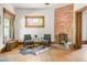 Living room showcasing an exposed brick fireplace and decorative rug at 2845 Quitman St, Denver, CO 80212