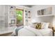 Main bedroom with built-in shelves, large window, and bed with decorative pillows at 2845 Quitman St, Denver, CO 80212