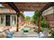 Underneath a pergola featuring a wooden table, seating, and backyard views at 2845 Quitman St, Denver, CO 80212