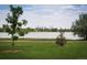 Beautiful skyline view of the city across the lake and grassy field with decorative trees at 2845 Quitman St, Denver, CO 80212