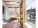Bright and airy sunroom with brick flooring, skylights, and sliding doors leading to the backyard at 2845 Quitman St, Denver, CO 80212