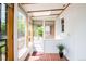 Light-filled sunroom with brick floors, large windows offering views of the lush backyard at 2845 Quitman St, Denver, CO 80212
