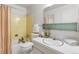 A compact bathroom with a combo tub and shower, a toilet, and a sink at 9179 E Oxford Dr, Denver, CO 80237