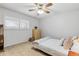 A bedroom with neutral tones, carpet, and a ceiling fan with a light at 9179 E Oxford Dr, Denver, CO 80237