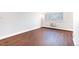 Spacious bedroom with hardwood floors, bright windows and an air conditioning unit at 969 S Pearl St # 305, Denver, CO 80209
