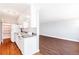 Charming kitchen with white cabinetry, granite countertops and adjacent room with hardwood floors at 969 S Pearl St # 305, Denver, CO 80209