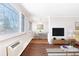 Bright living room with an adjacent dining area with large windows and hardwood floors at 969 S Pearl St # 305, Denver, CO 80209
