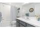 Bathroom featuring shower/tub, decorative mirror, and modern vanity with white countertops at 2455 Alpine St, Longmont, CO 80504