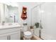 Clean bathroom with a glass-enclosed shower, white vanity, and decorative accents at 2455 Alpine St, Longmont, CO 80504