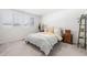 Bright bedroom with two windows, wood frame bed and a nightstand at 2455 Alpine St, Longmont, CO 80504
