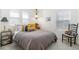 Comfortable bedroom with soft, natural light from window and comfy decorative pillows and quilt at 2455 Alpine St, Longmont, CO 80504