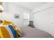 Bright bedroom features soft lighting, colorful pillows, and closet space at 2455 Alpine St, Longmont, CO 80504