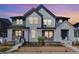 Charming two-story home with Hardie board siding, welcoming front porch, and professional landscaping at 2455 Alpine St, Longmont, CO 80504