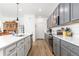 Stylish kitchen with stainless steel appliances, gray cabinets, white countertops, and modern fixtures at 2455 Alpine St, Longmont, CO 80504