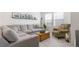 Bright living room with a comfortable sectional sofa, wood chest coffee table, and lots of natural light at 2455 Alpine St, Longmont, CO 80504