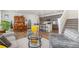 Bright, open-concept living room with wood floors, comfortable seating, and a modern kitchen in the background at 2455 Alpine St, Longmont, CO 80504