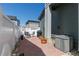Cozy backyard patio with stone floor, potted plants, and a grill at 2455 Alpine St, Longmont, CO 80504