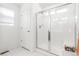 Clean, bright bathroom featuring a glass enclosed shower with white tiled walls at 2455 Alpine St, Longmont, CO 80504