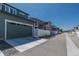 Row of modern townhomes with attached garages and white fences along a paved street at 2455 Alpine St, Longmont, CO 80504