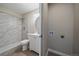 Modern bathroom featuring marble tile shower with white vanity and laundry hookups at 4110 Hale Pkwy # 1E, Denver, CO 80220