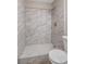 Close-up of the tiled shower stall with a hexagon tile shower floor at 4110 Hale Pkwy # 1E, Denver, CO 80220
