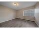 Neutral bedroom with a large window, modern flooring, and a heater at 4110 Hale Pkwy # 1E, Denver, CO 80220