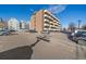 Apartment complex exterior with parking lot, featuring multiple balconies on a sunny day at 4110 Hale Pkwy # 1E, Denver, CO 80220