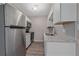A compact kitchen showcasing stainless steel appliances, granite countertops, and white cabinets at 4110 Hale Pkwy # 1E, Denver, CO 80220
