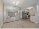 A spacious living area featuring wood floors, a mirrored wall, and stainless steel appliances at 4110 Hale Pkwy # 1E, Denver, CO 80220
