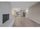 Living room featuring a fireplace, mirrored closet doors, and view into the kitchen at 4110 Hale Pkwy # 1E, Denver, CO 80220