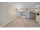 Open floor plan with hardwood floors, a mirrored wall, and stainless steel appliances in view at 4110 Hale Pkwy # 1E, Denver, CO 80220