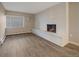 The living room has a lovely fireplace, beautiful wood floors, and a bright window at 4110 Hale Pkwy # 1E, Denver, CO 80220