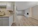Bright living area offering a fireplace, wood floors, and a view into an adjacent room at 4110 Hale Pkwy # 1E, Denver, CO 80220