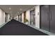 Modern hallway with elevator and carpeted floors at 12983 W Ida Ave # 400, Littleton, CO 80127