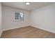 Bright bedroom featuring neutral walls, wood floors, and natural light from the window at 6055 W Warren, Lakewood, CO 80227