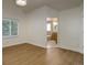 Bright bedroom with hardwood floors and an ensuite bathroom featuring tile surround tub at 6055 W Warren, Lakewood, CO 80227