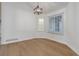 Bright dining room with hardwood floors, modern lighting, and a built-in display cabinet at 6055 W Warren, Lakewood, CO 80227