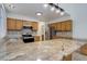 Open kitchen featuring granite countertops, stainless steel appliances, and wooden cabinetry at 6055 W Warren, Lakewood, CO 80227