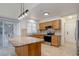 Modern kitchen with granite countertops, stainless steel appliances, and a breakfast bar at 6055 W Warren, Lakewood, CO 80227
