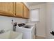 Laundry room featuring side by side washer and dryer, upper cabinets, and a sink at 6055 W Warren, Lakewood, CO 80227