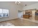 Open-concept room with a window and adjoining kitchen with wood cabinets and island at 6055 W Warren, Lakewood, CO 80227