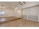 Bright living room with vaulted ceilings, hardwood floors, and staircase at 6055 W Warren, Lakewood, CO 80227