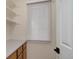 Pantry featuring wooden cabinets, a countertop, and white adjustable shelving at 6055 W Warren, Lakewood, CO 80227