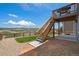 Landscaped backyard with deck and stairs at 15866 Little Bluestem Rd, Monument, CO 80132