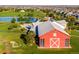 Aerial view of a red barn in a Reunion community, surrounded by green space and a pond at 9976 Pitkin St, Commerce City, CO 80022