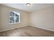 Bedroom with wood-look flooring and natural light from a large window at 9976 Pitkin St, Commerce City, CO 80022